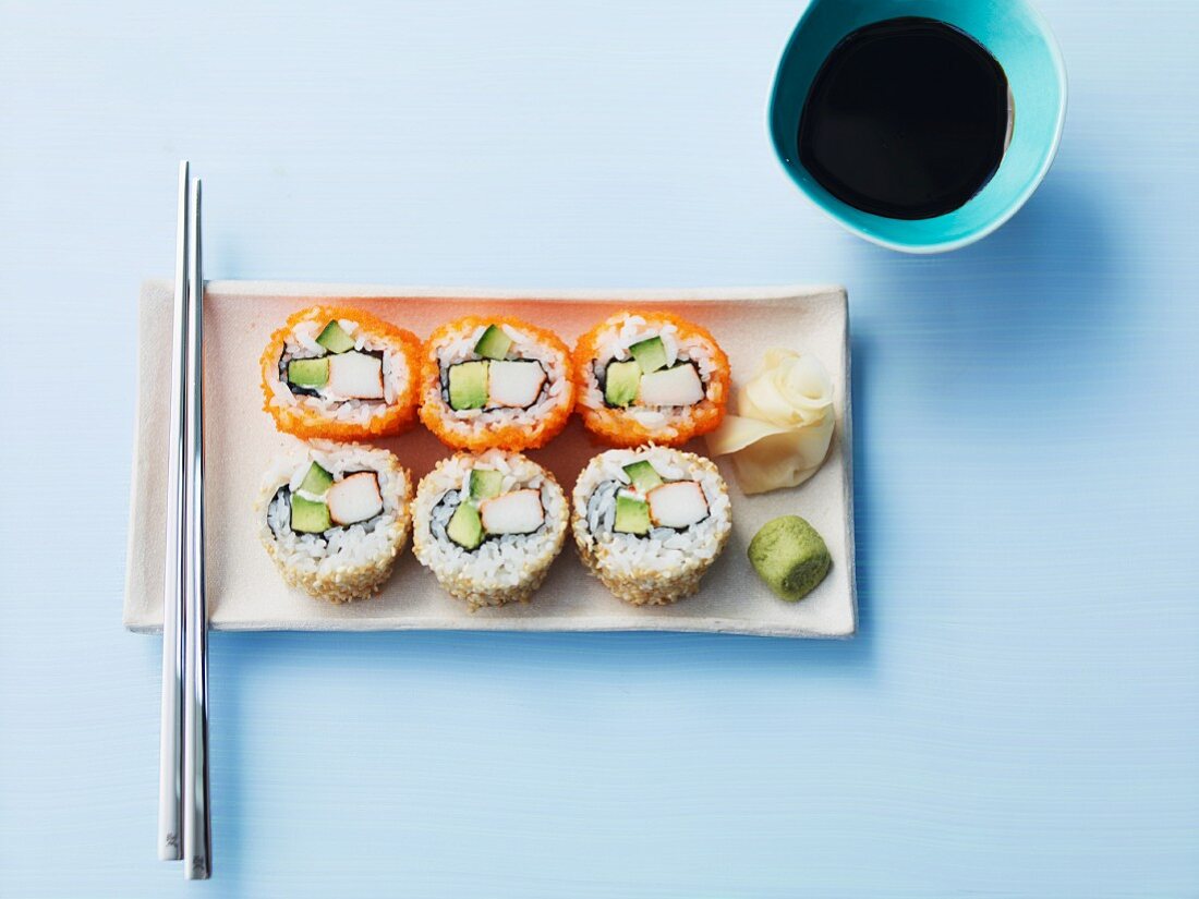 Six California rolls with soy sauce, ginger and wasabi