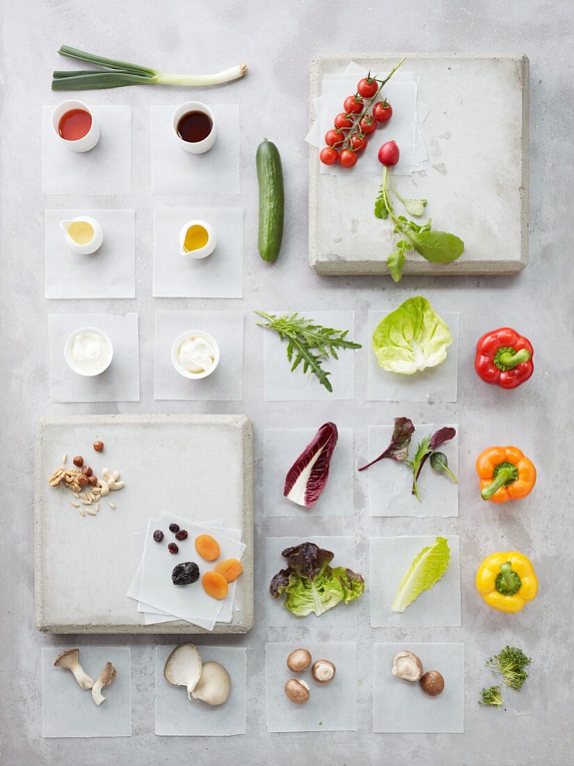 Still life with lettuce leaves, vegetables, mushroom, nuts, dried fruit and sauces