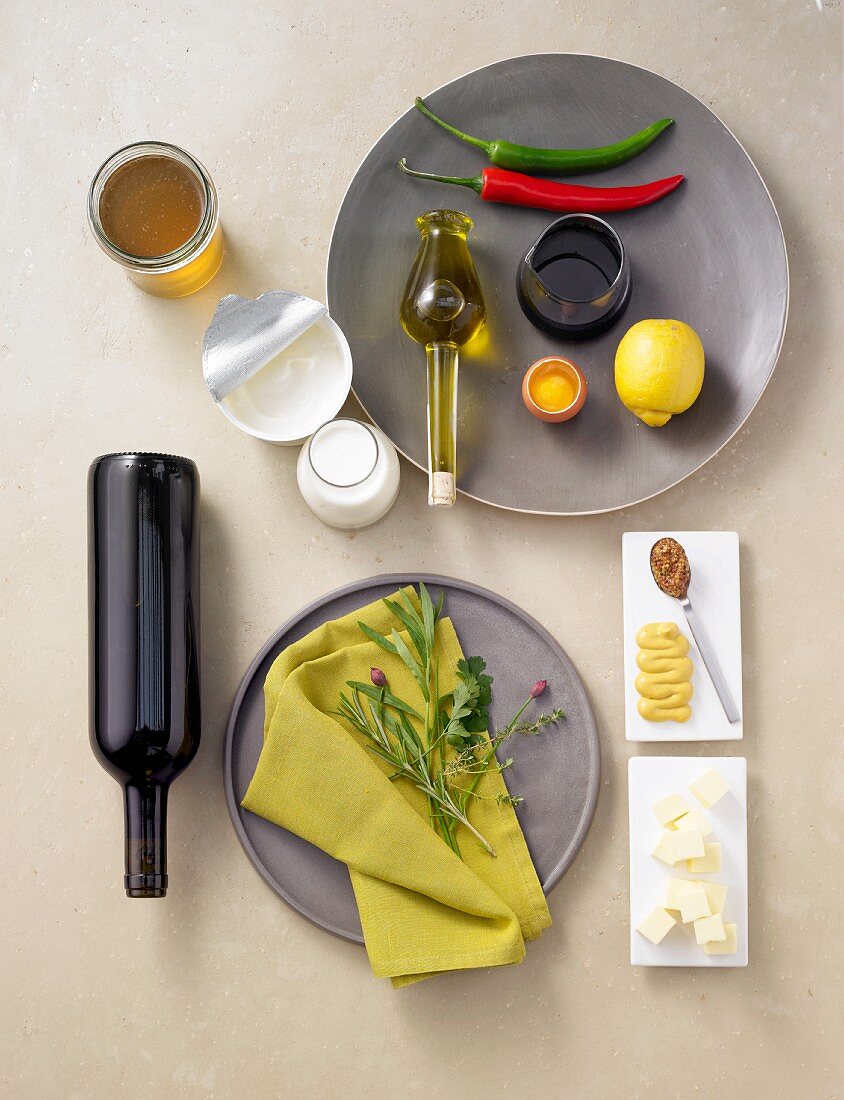 Still life with herbs, butter, mustard, foodstuff, lemon, chili peppers and wine