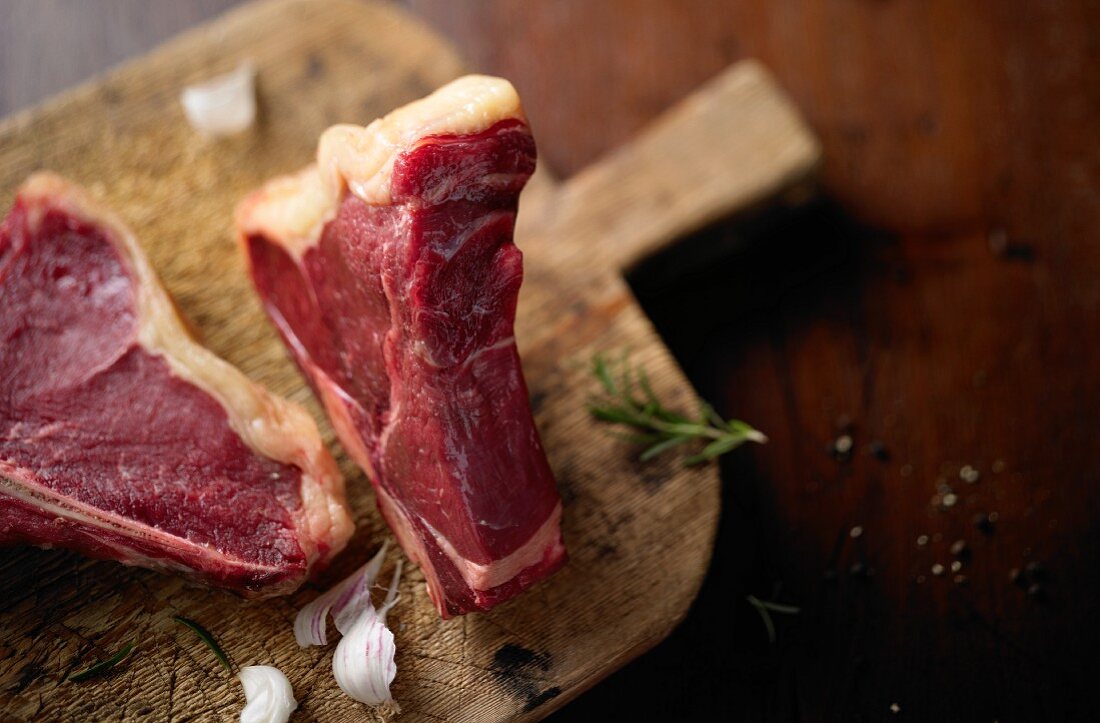 Beef steaks on a wooden cutting board