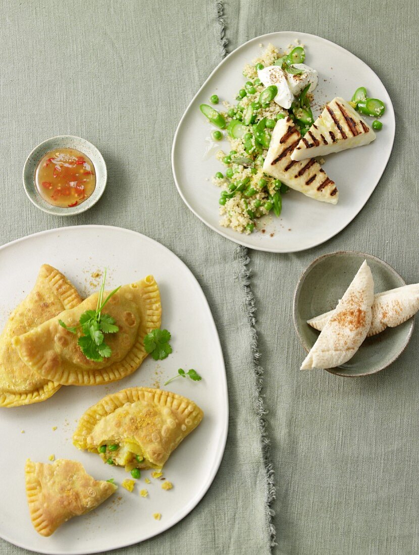Samosas and couscous with asparagus, mint and haloumi