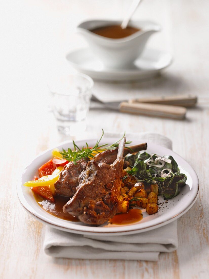 Lamb cutlets with roast potatoes and vegetables