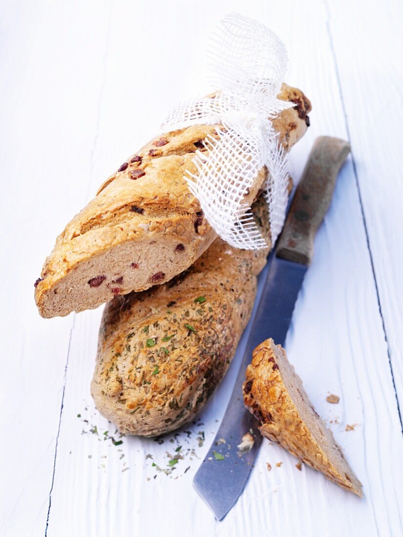 Bacon bread and herb bread with a bread knife