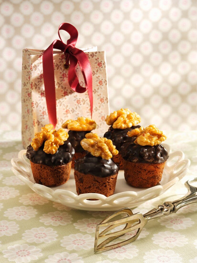 Mini muffins with chocolate icing and walnuts
