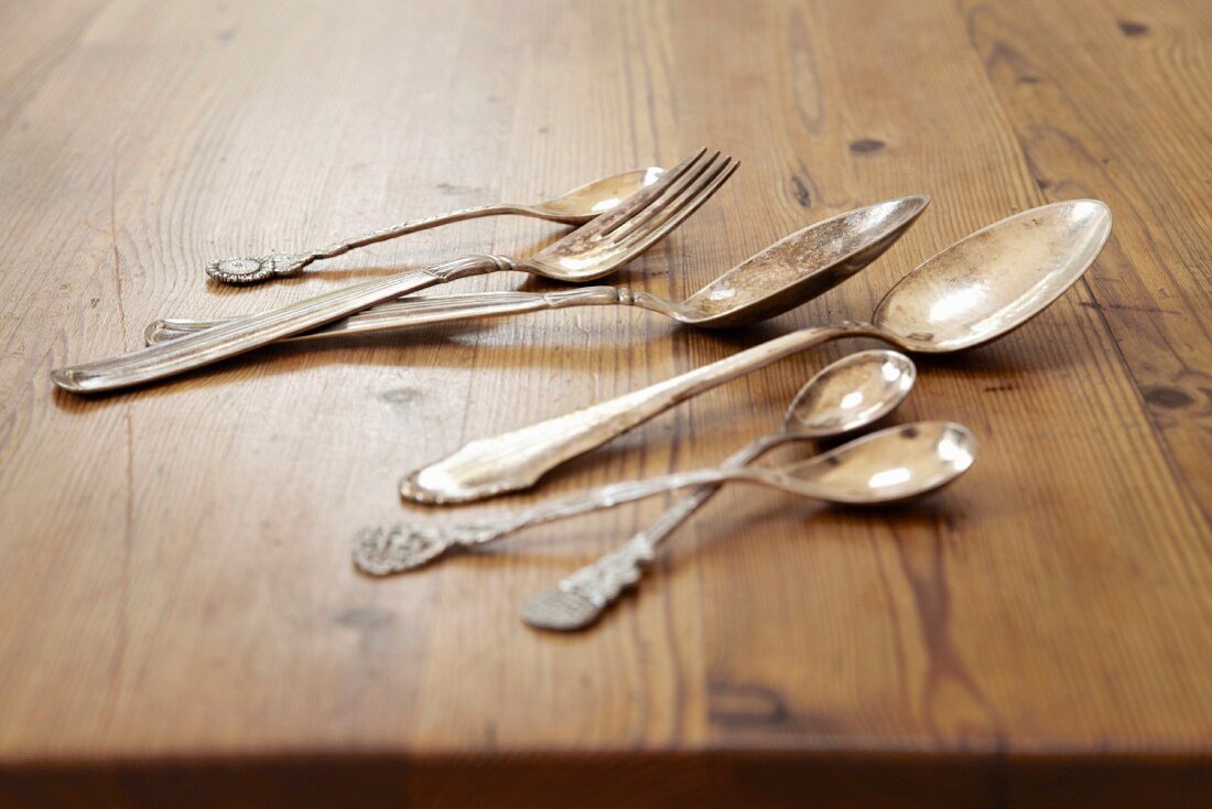 Silver cutlery on a wooden table