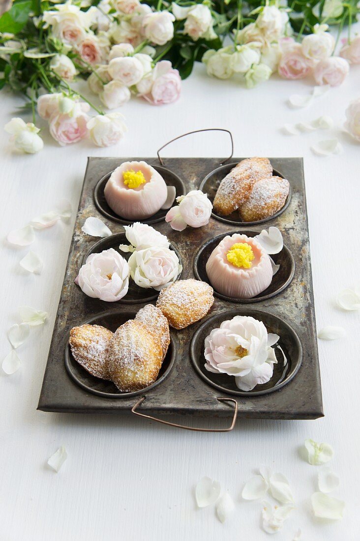 Madeleines and wagashi with roses in an antique baking tray with roses
