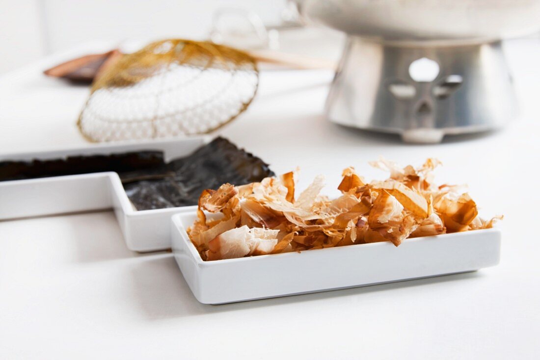 Ingredients for Japanese dashi stock: bonito flakes and kelp (konbu) with utensils
