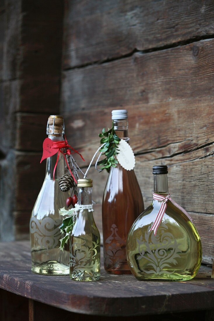 Bottles of wine decorated as gifts with ornaments, pendants and ribbons