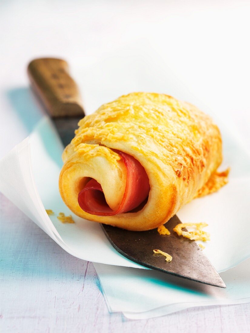 A puff pastry roll filled with ham and cheese