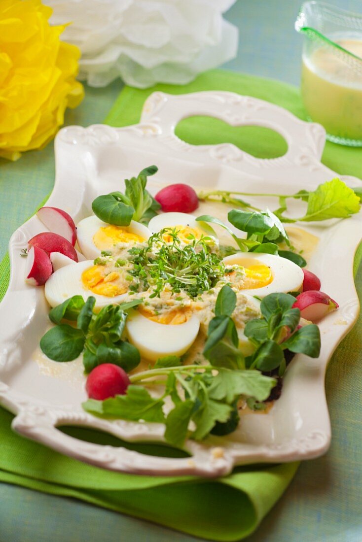 Hard-boiled eggs with horseradish, radishes, lamb's lettuce and cress for Easter