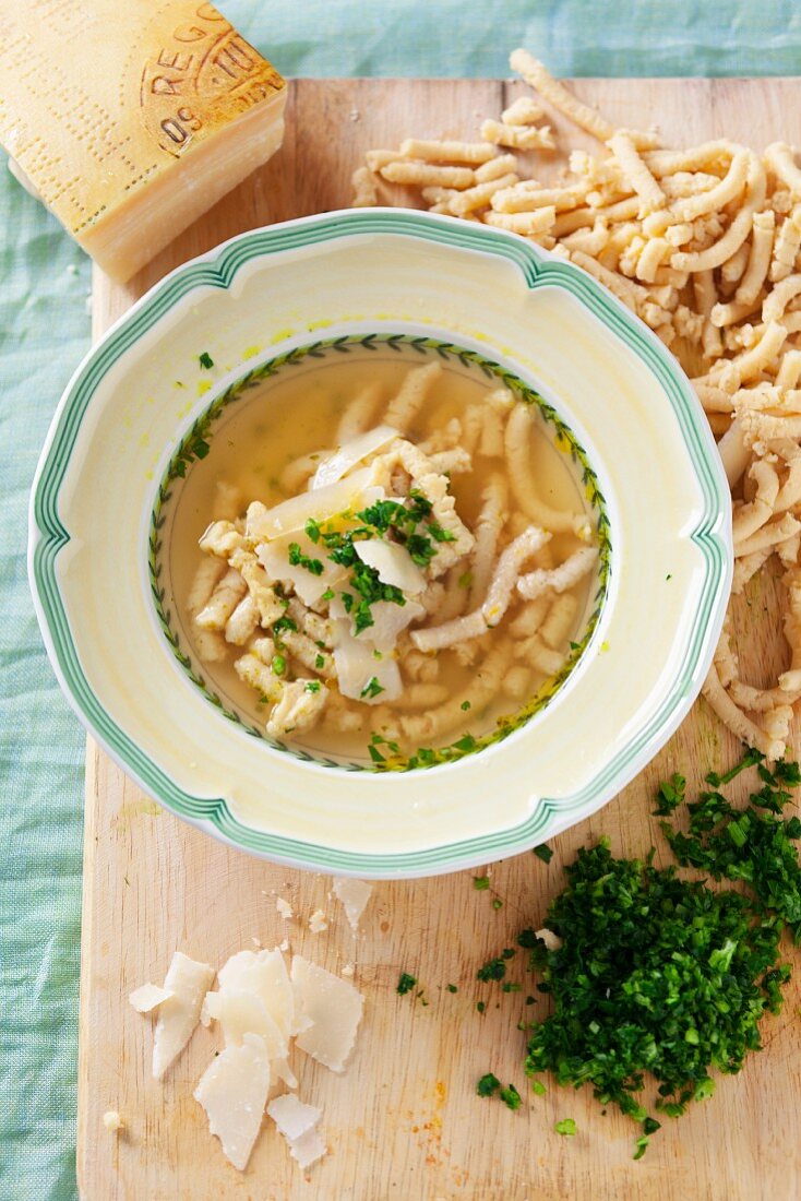 Pasta soup with passatelli pasta, parmesan and parsley (Italy)