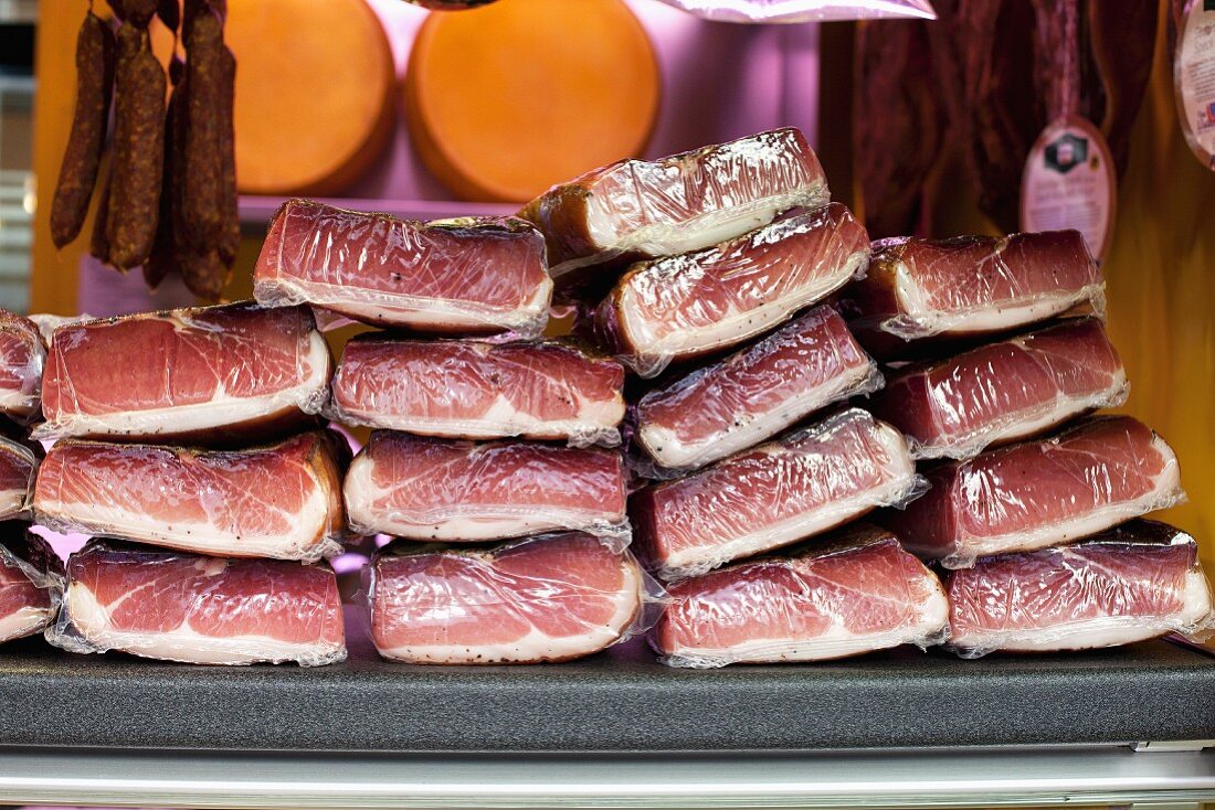 A stack of packaged dry-cured ham at the market