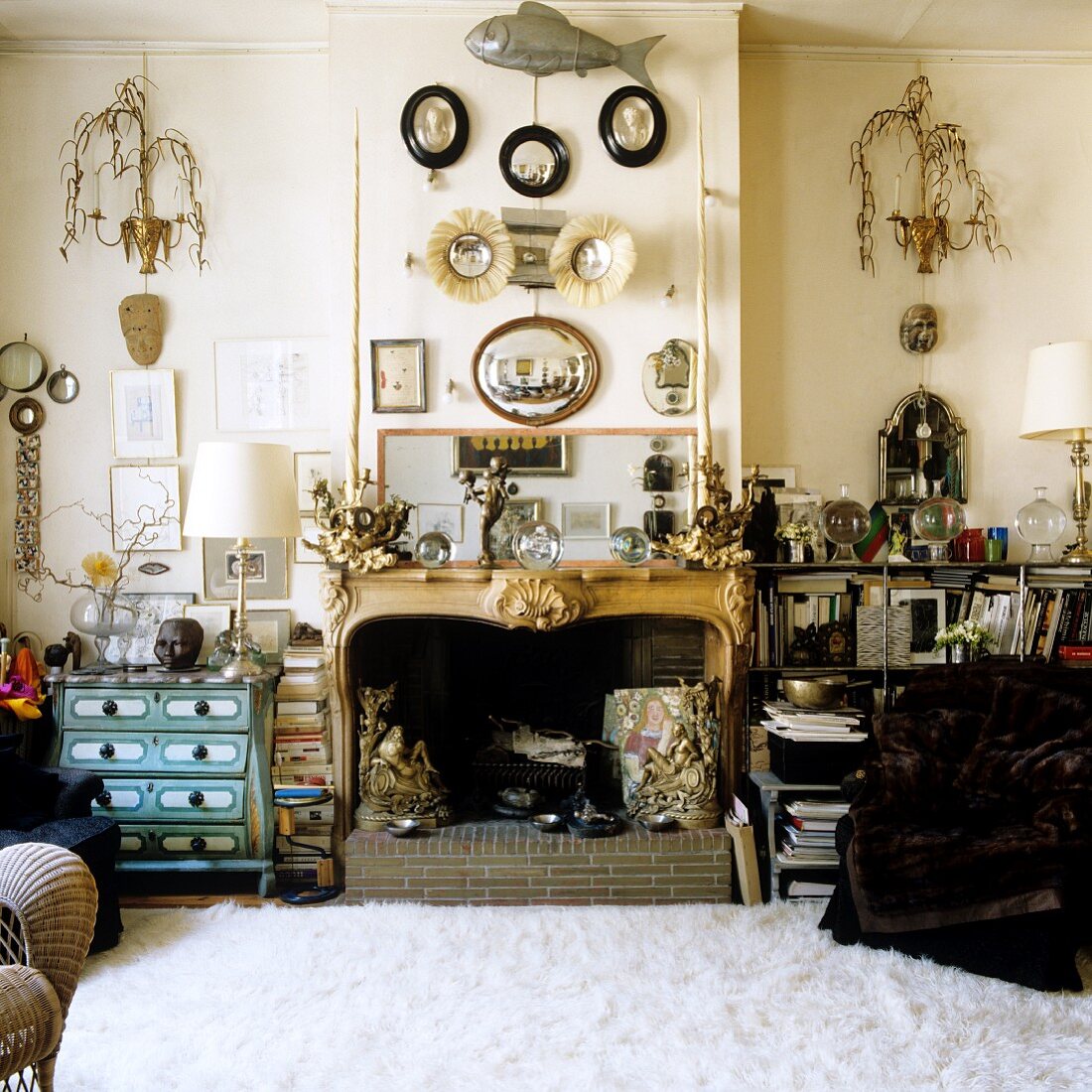 Open fireplace decorated with sculptures and collection of ornaments in living room