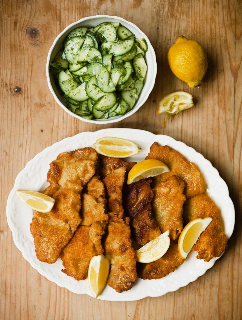 Wiener Schnitzel (breaded veal escalope from Vienna) with cucumber salad (view from above)