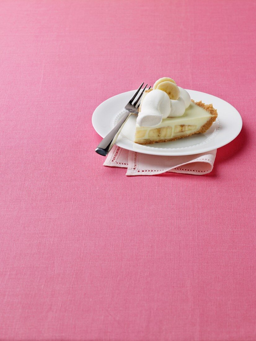 A Slice of Banana Cream Pie on a White Plate
