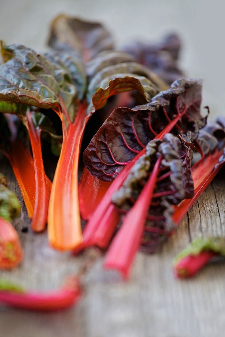 Red chard leaves on a wooden surface