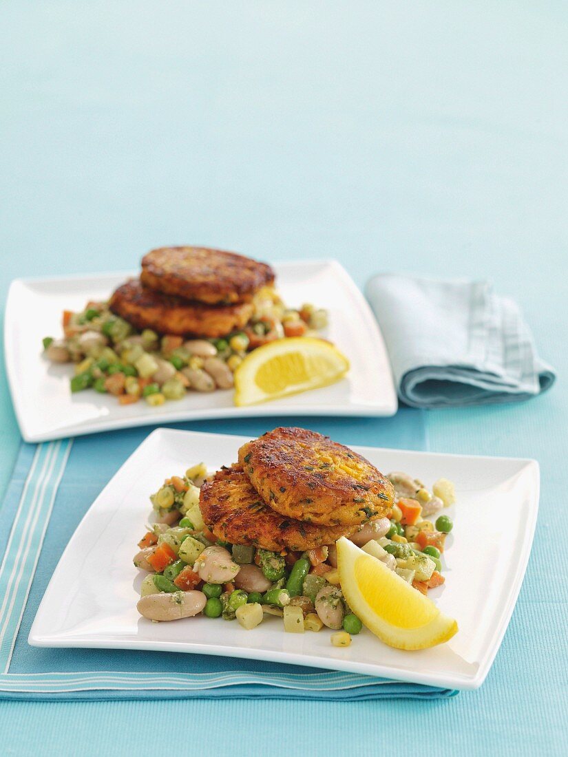 Squash fritters on vegetables flavoured with pesto