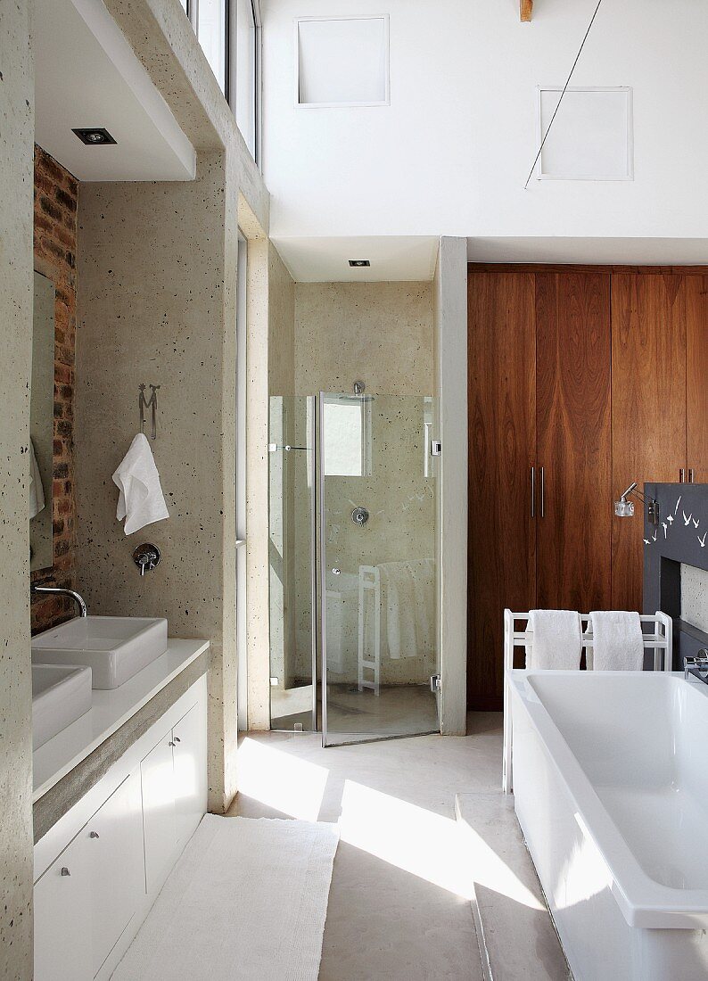 Spacious bathroom with twin washbasins, bathtub & separate, glazed shower area