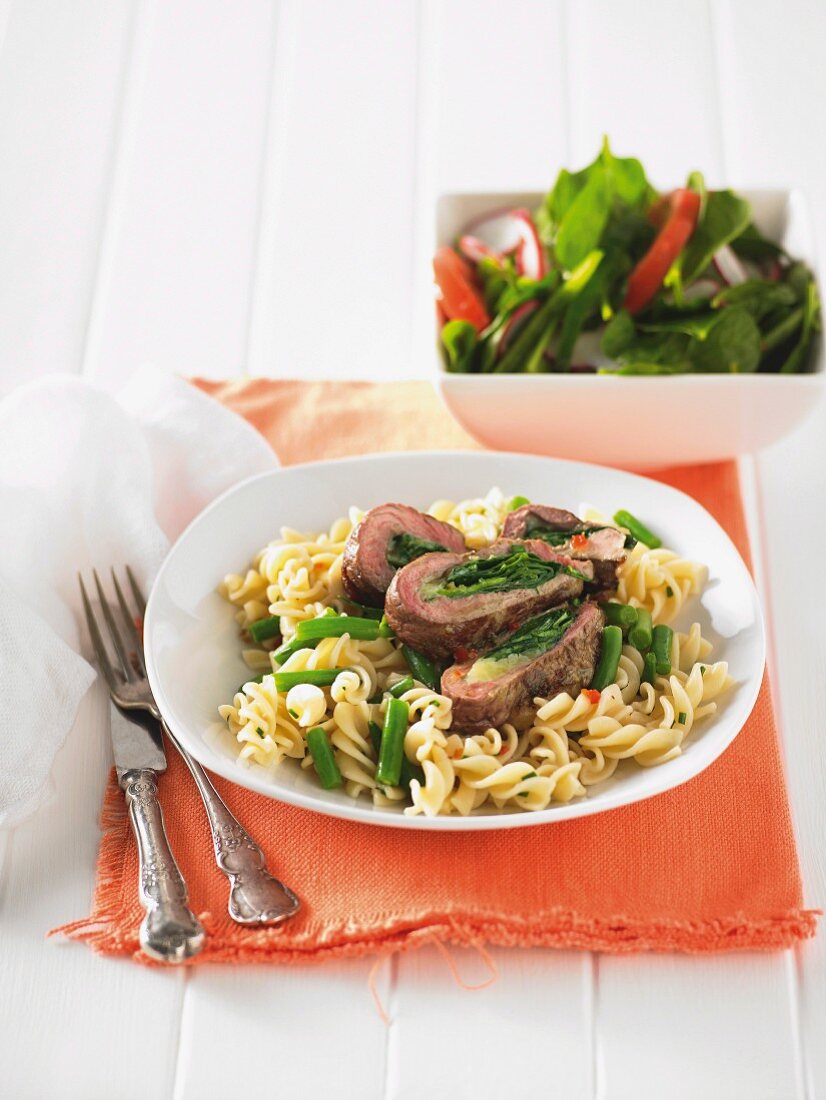 Lamb leg steaks stuffed with spinach, with pasta spirals