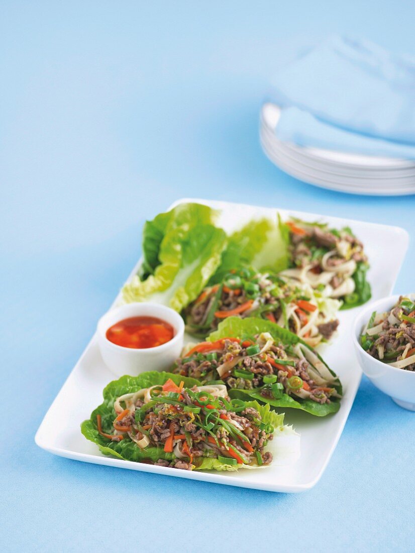 Minced meat with noodles on lettuce leaves