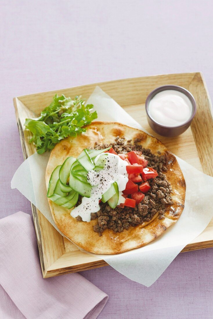 Flatbread with minced meat, tomatoes, yoghurt and cucumber