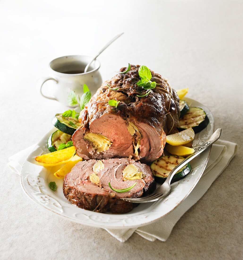 Leg of lamb with artichoke filling, served with vegetables
