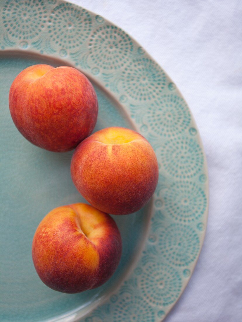 Three fresh peaches