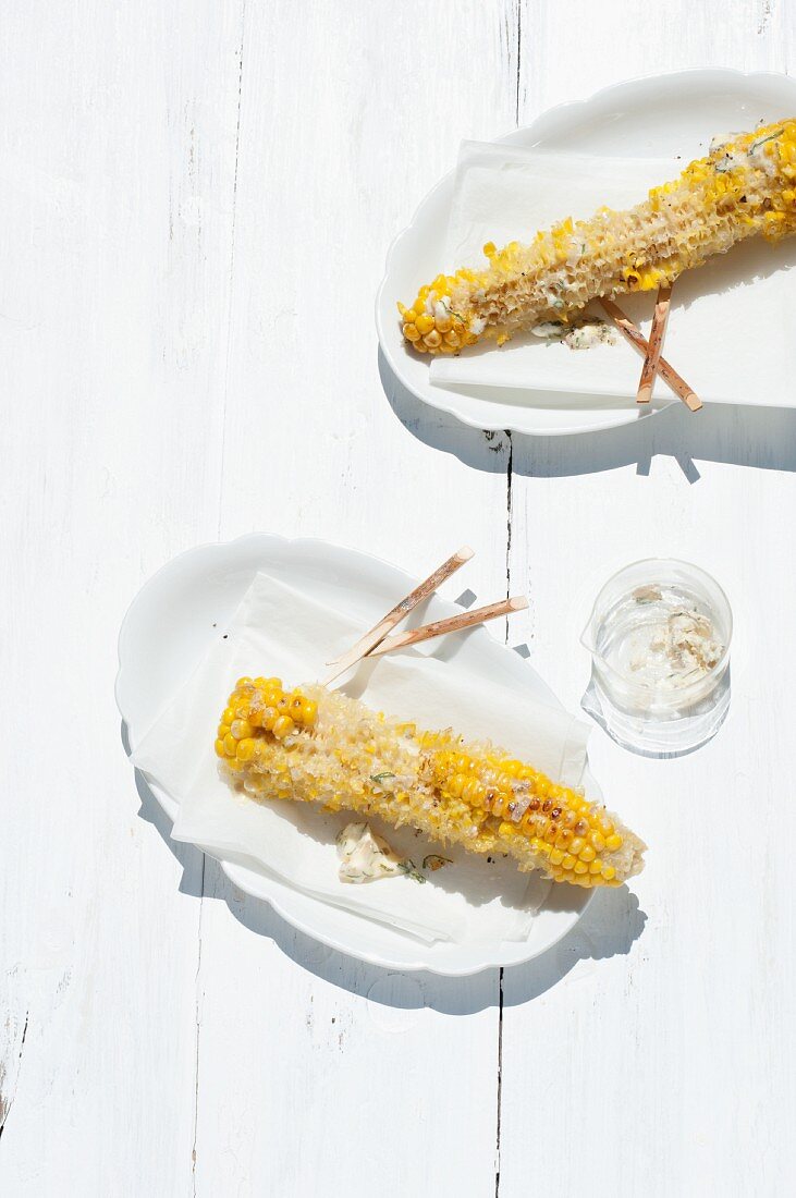 Remnants of barbecued corn on the cob on plates