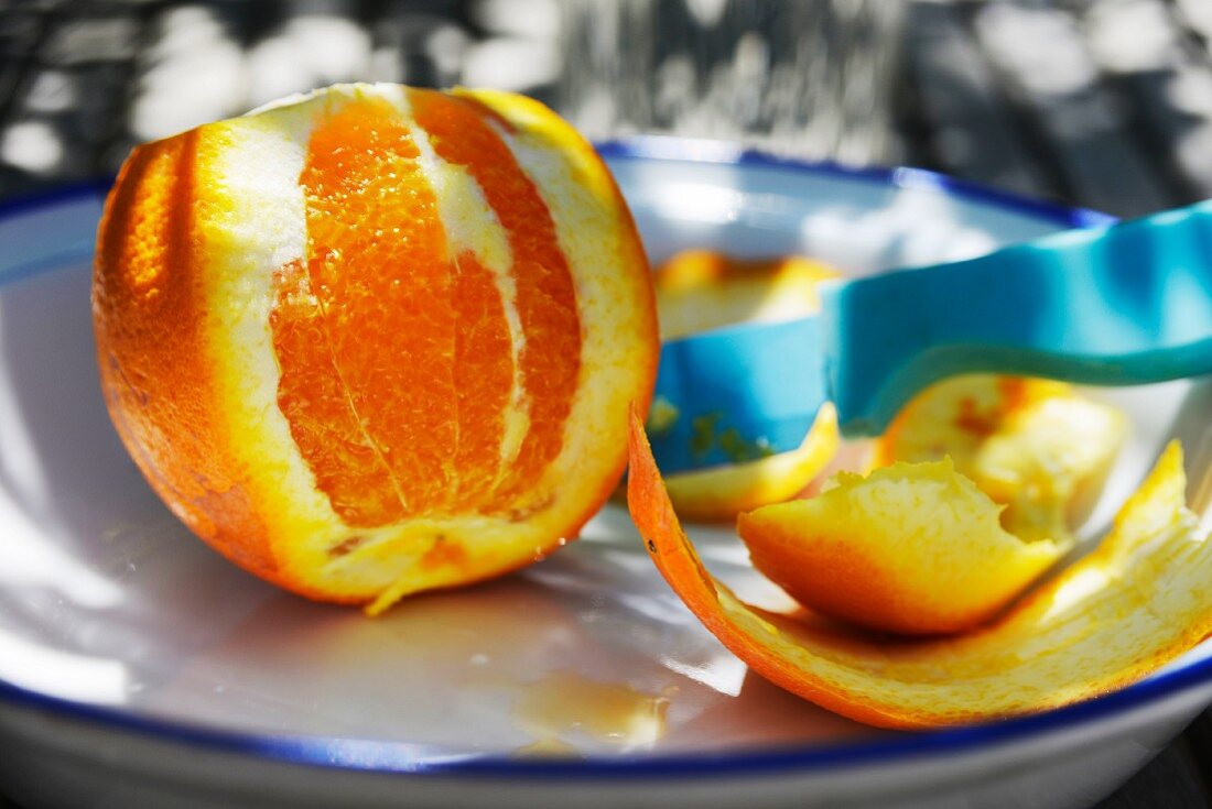 An orange, partly peeled
