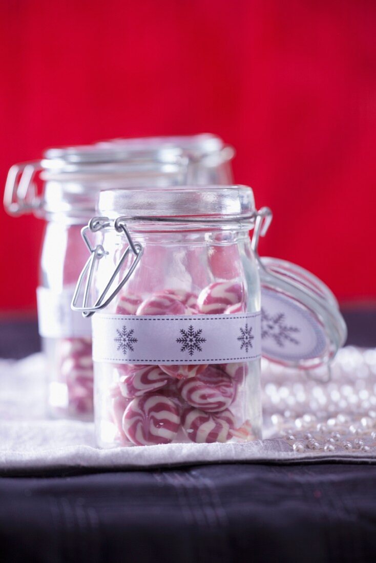 Rot-weiße Pfefferminzbonbons in Vorratsgläsern zu Weihnachten