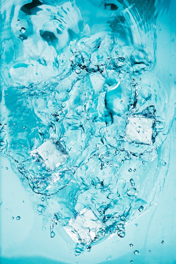Ice Cubes Splashing into Water