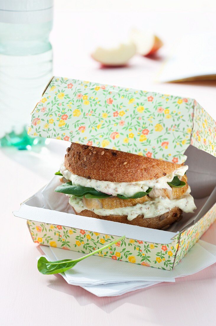 Wholemeal burger bun filled with apple quark, chicken breast and spinach