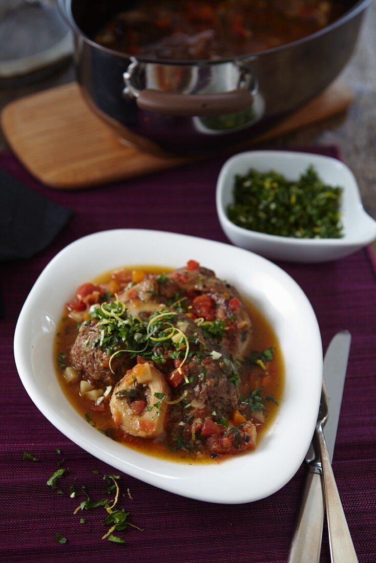 Veal shin with tomatoes and herbs