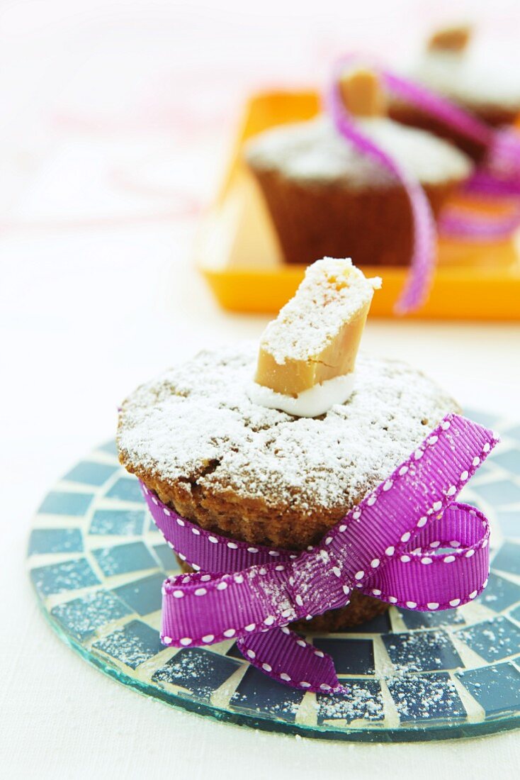 Hazelnut and toffee muffin with icing sugar, as a gift