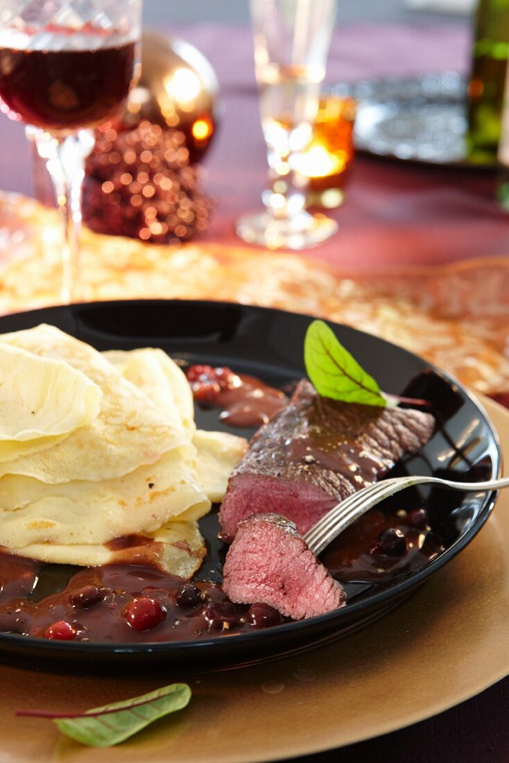 Venison steak with crepes and cranberry sauce for Christmas