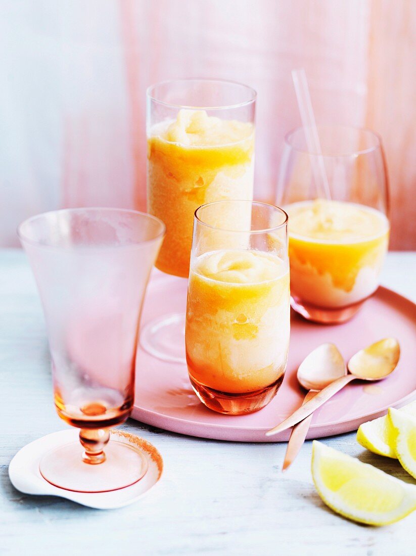 Melonen-Zitrus-Sorbet mit Gin in drei Gläsern