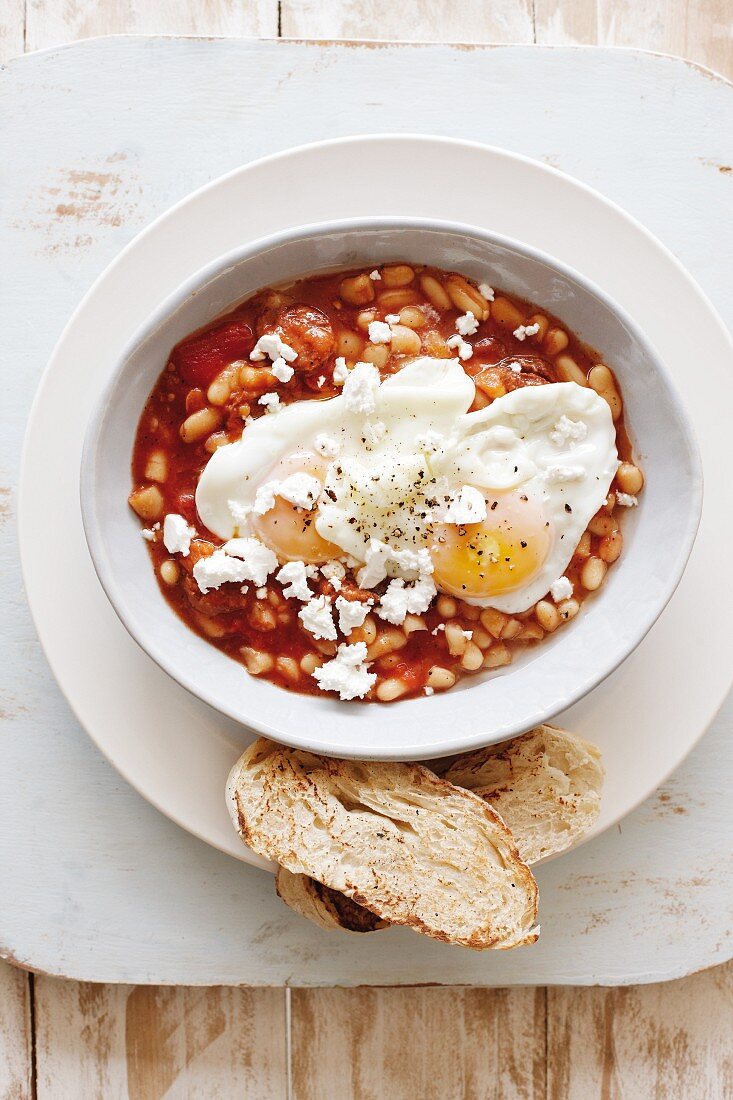 Bean stew with fried eggs and feta