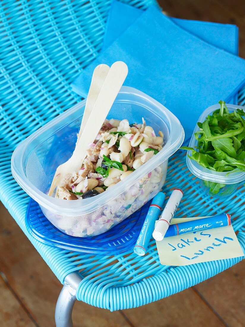 Bean salad with tuna and rocket in a plastic box