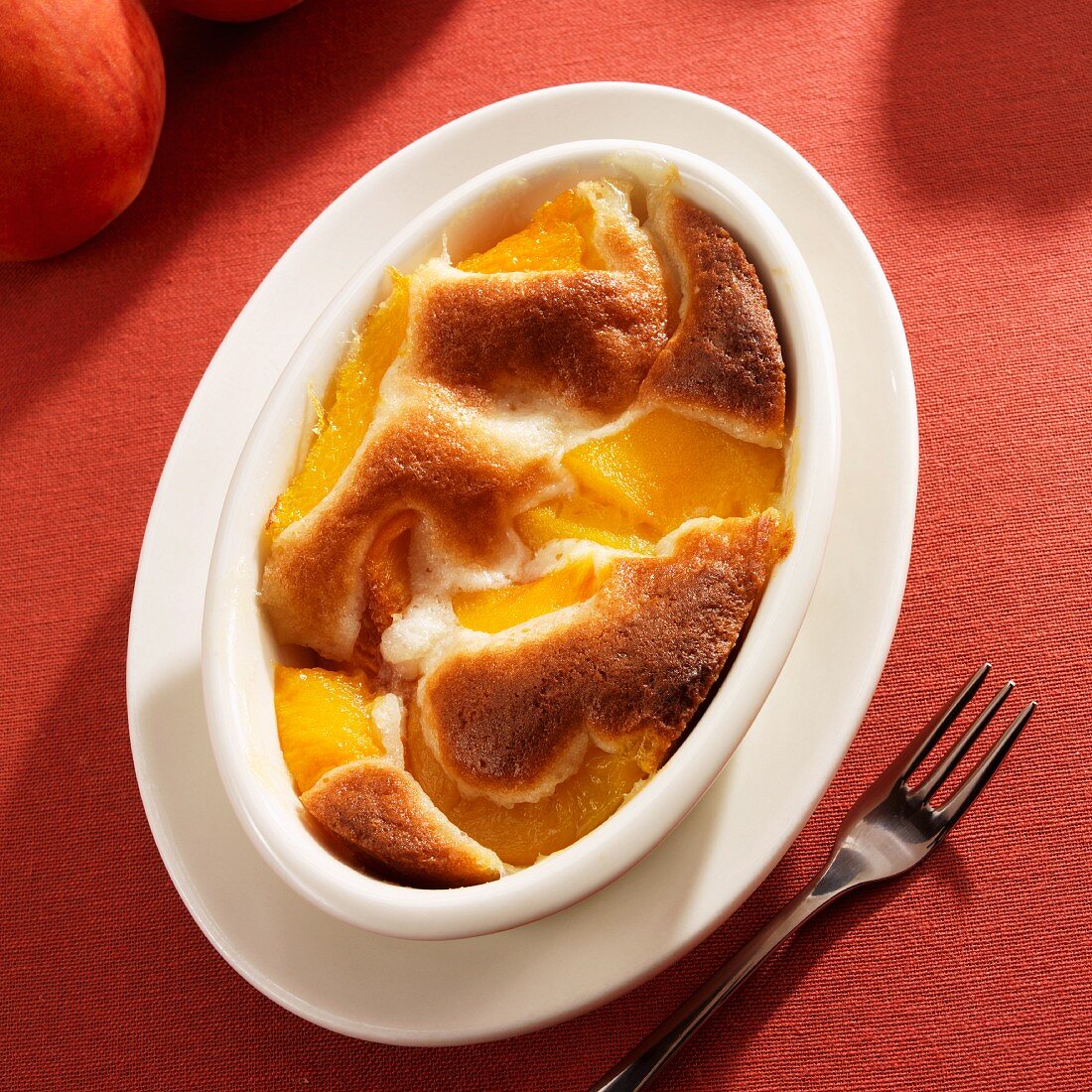 Peach Cobbler in an Oval Baking Dish; From Above