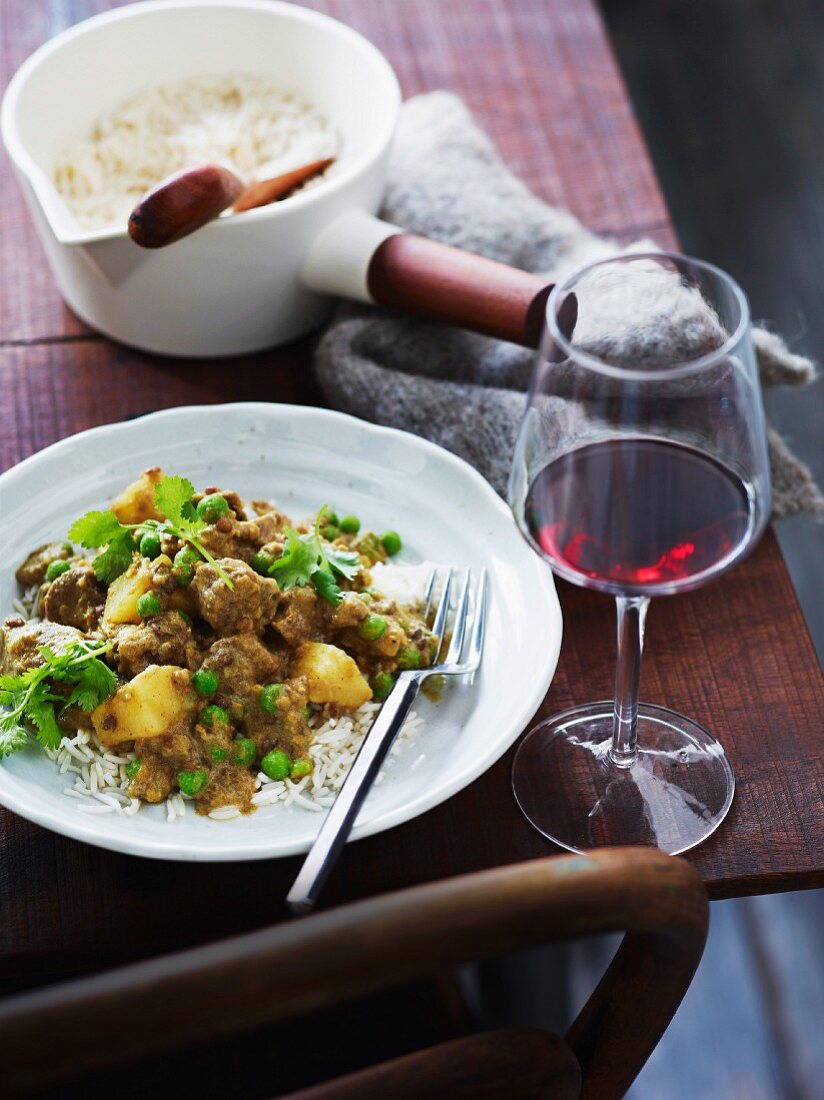 Indian lamb curry with potatoes and peas on a bed of rice
