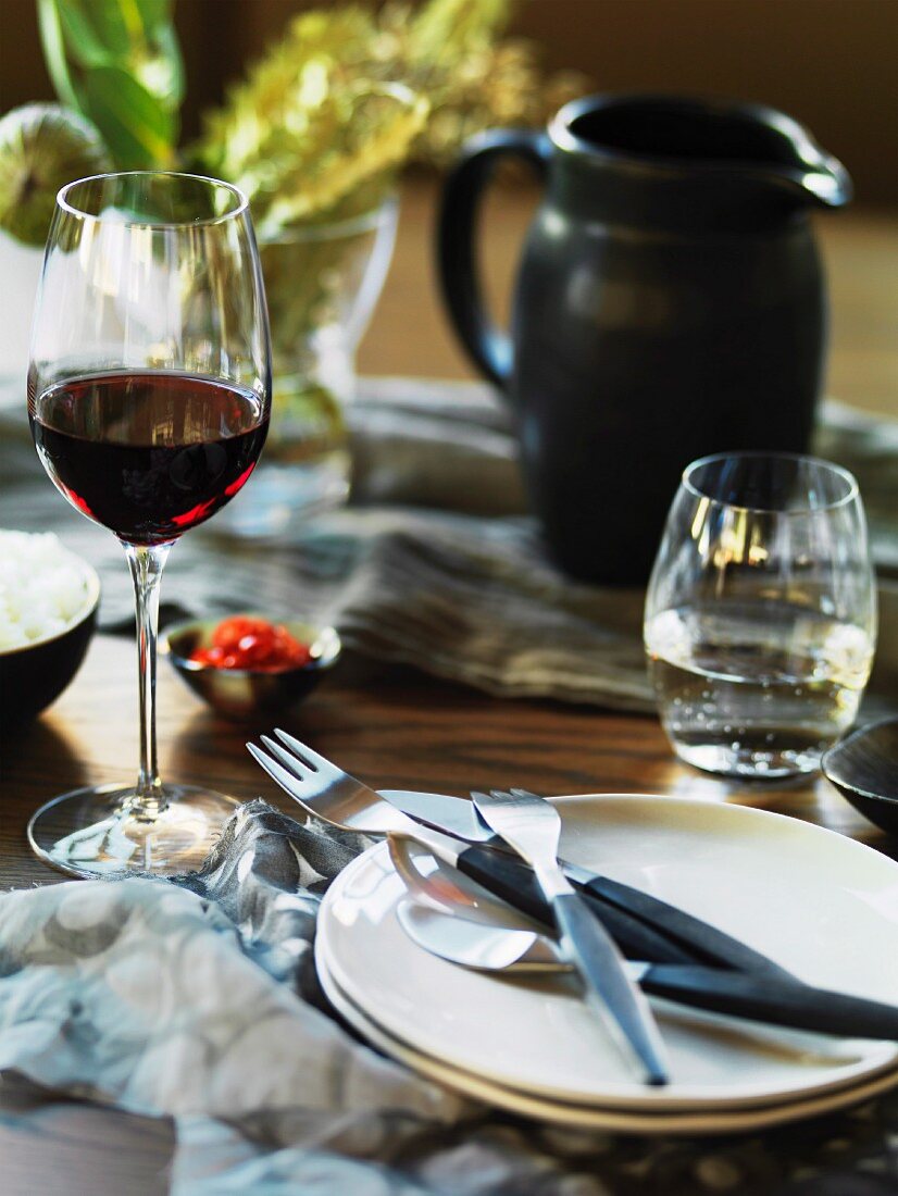 Rotwein- und Wasserglas auf gedecktem Tisch
