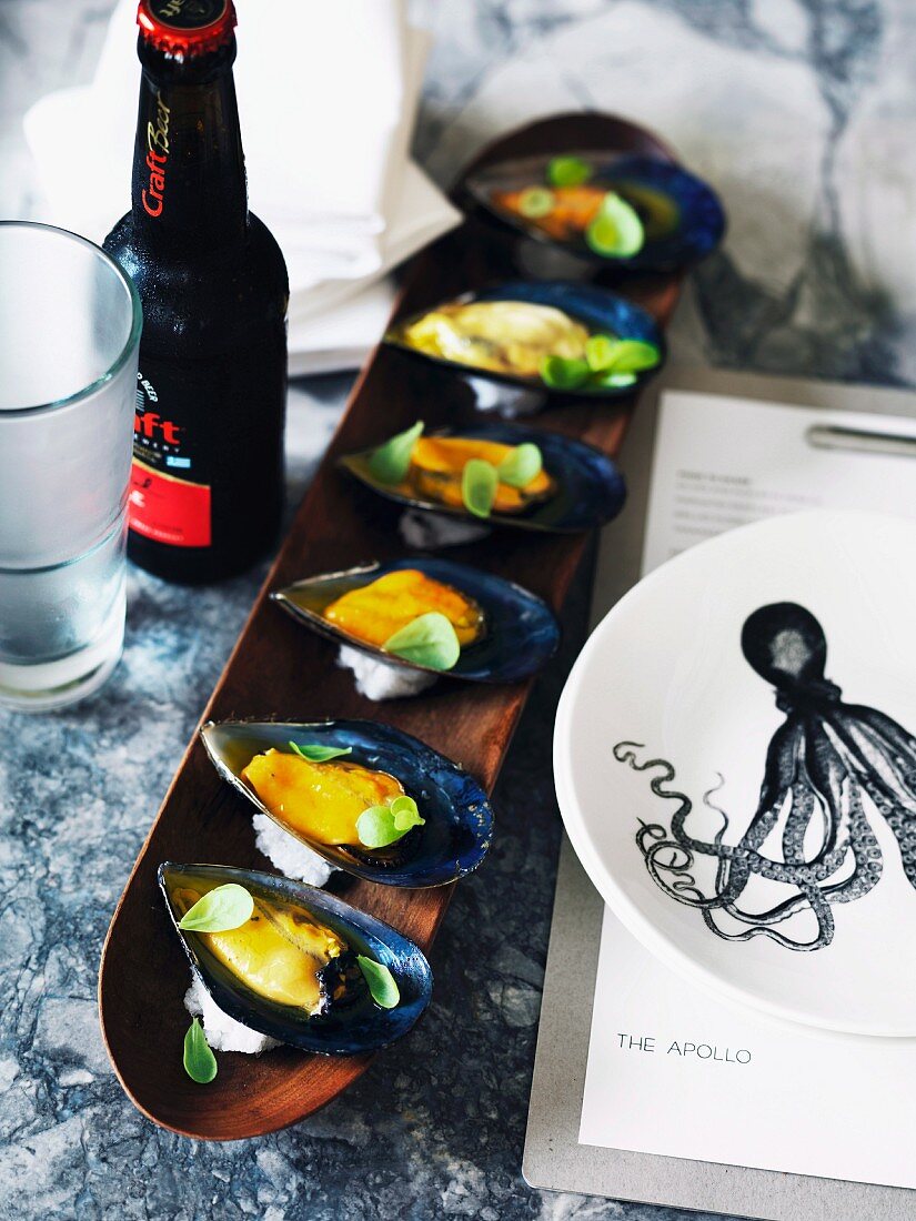 Mussels with a saffron vinaigrette and a long wooden dish