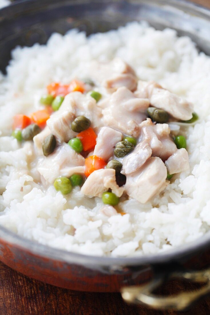 Chicken fricassee with rice in a copper bowl