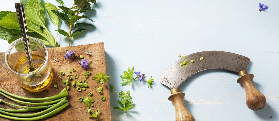 Herbs and a curved chopping blade