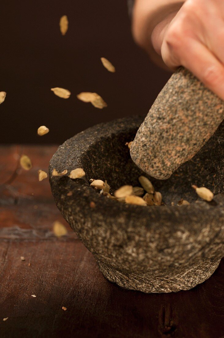 Seeds being crushed in a mortar