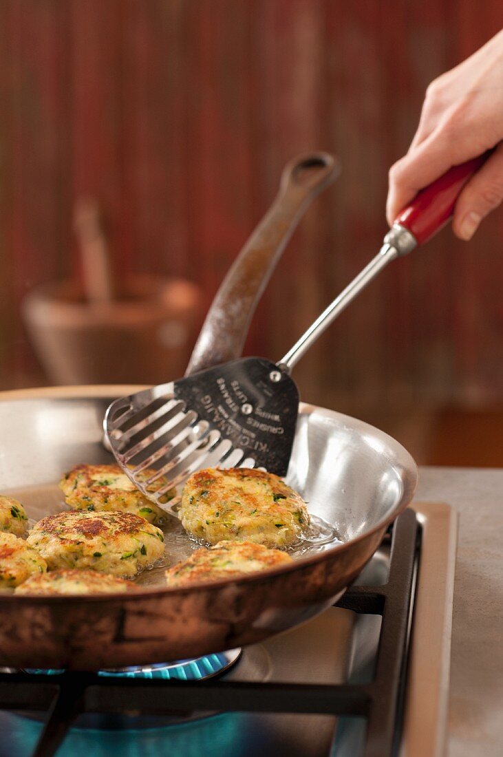 Trout fritters being fried in a pan