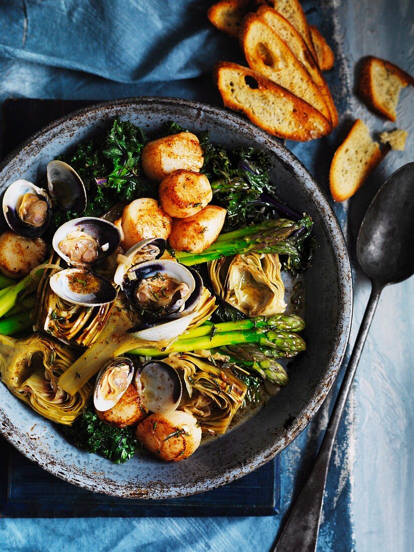 Barigoule of artichokes, asparagus and kale with scallops and clams