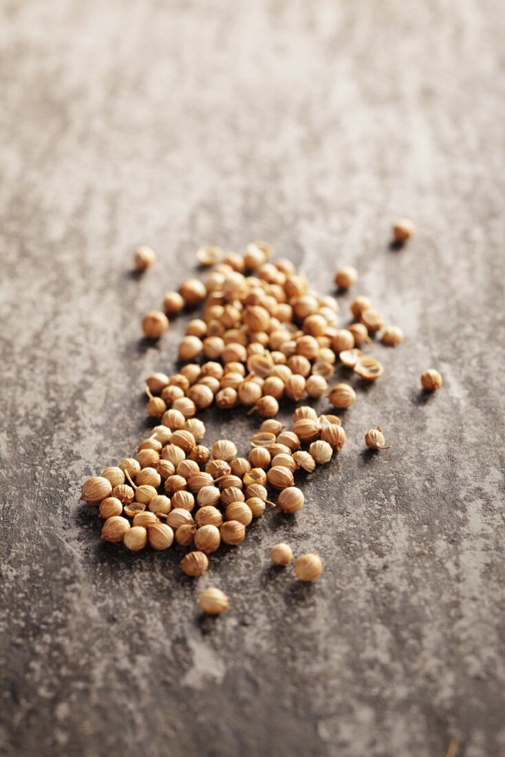 Coriander seeds on a grey surface