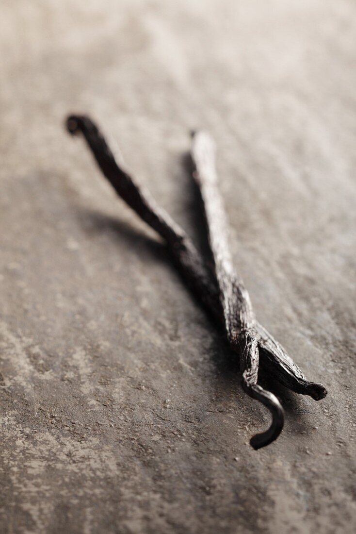 Vanilla pods on a grey surface