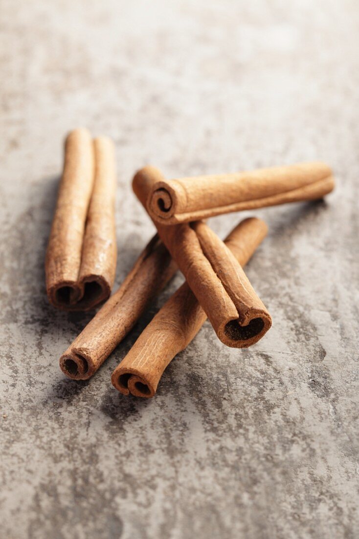 Cinnamon sticks on a grey surface